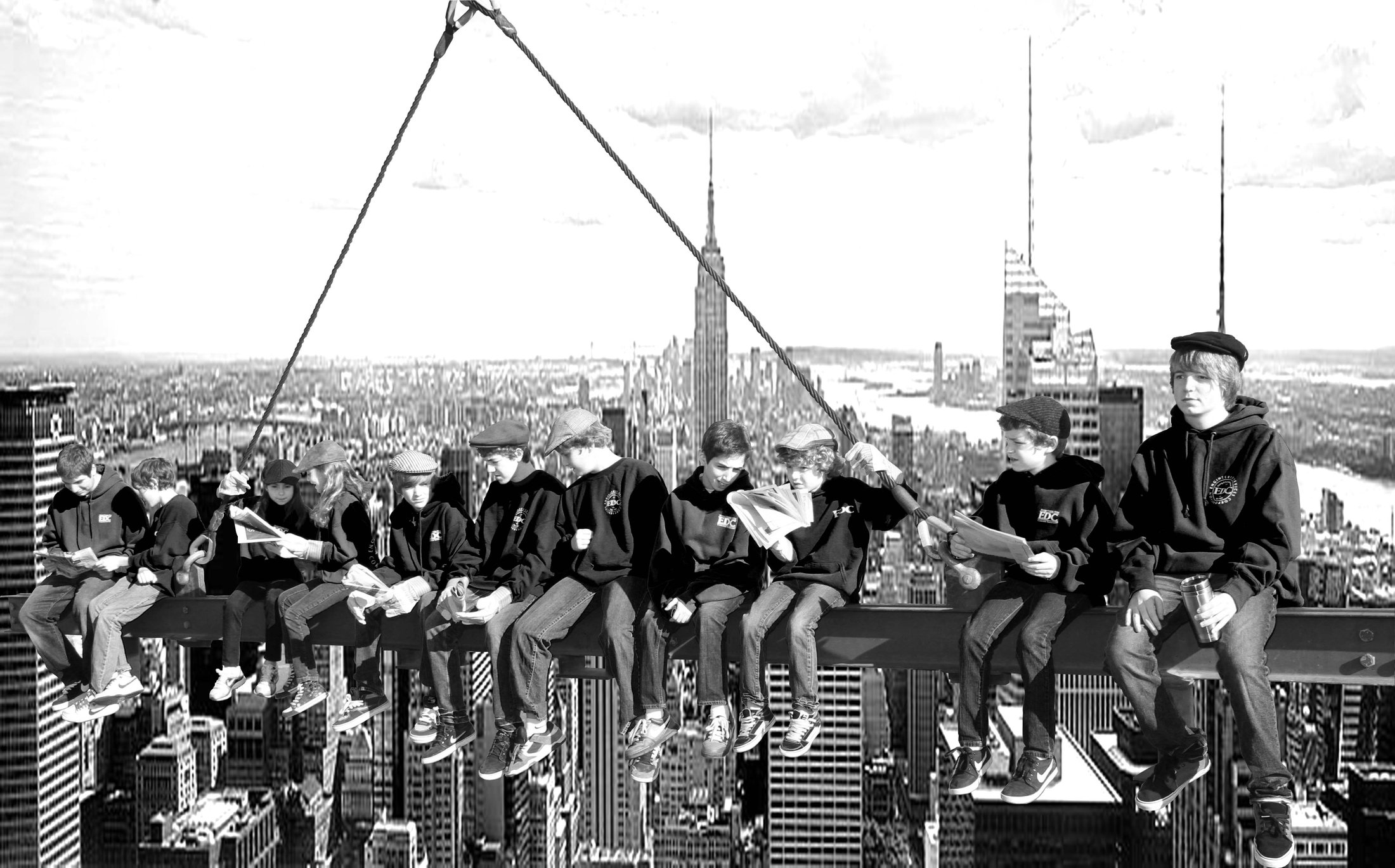 The fourth generation of the family, in EDC gear, seated on a steel beam above the Manhattan skyline, recreating the 1932 photograph Lunch atop a Skyscraper