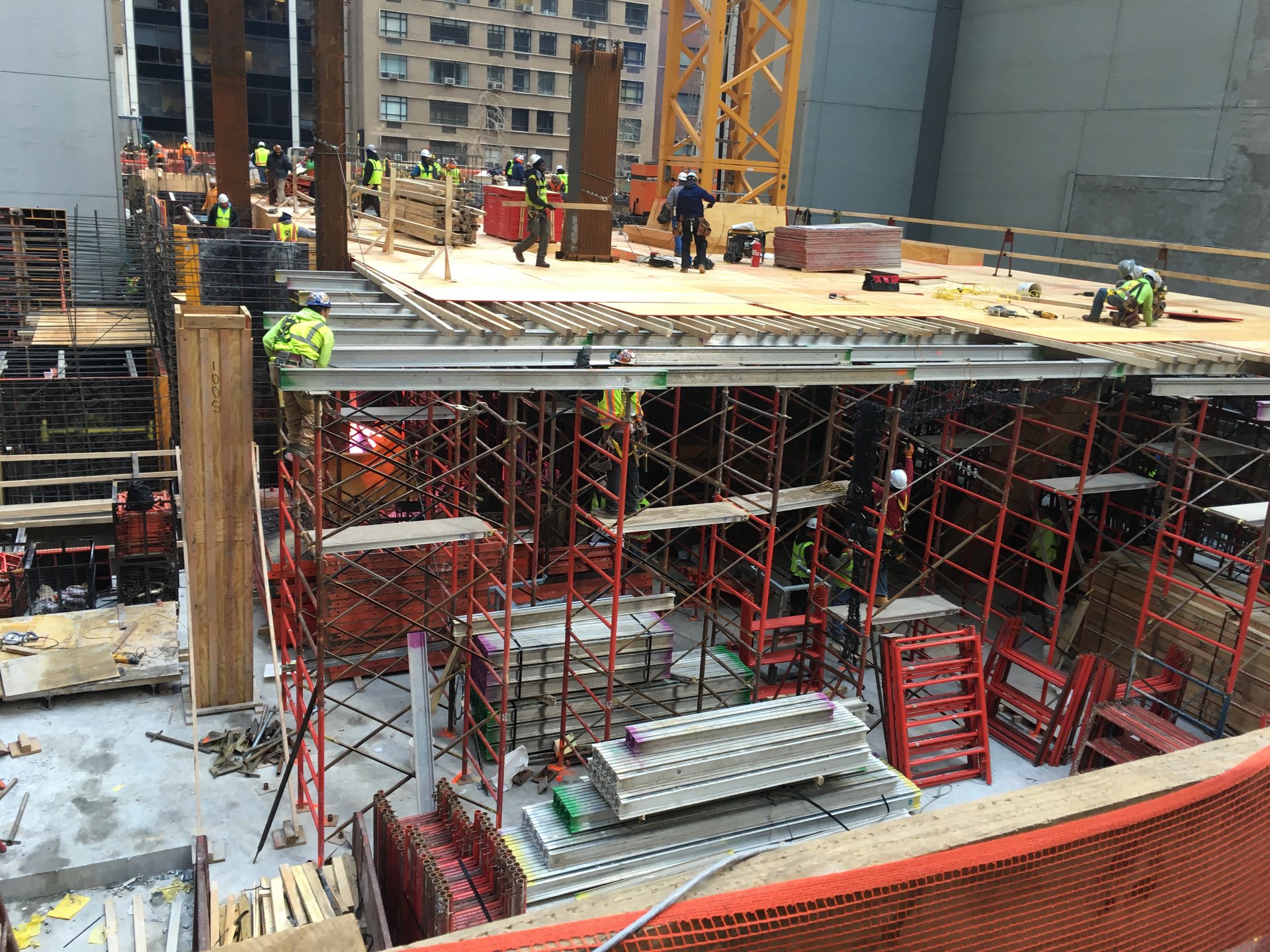Frame shoring and stringers under a working deck on the tight midtown site