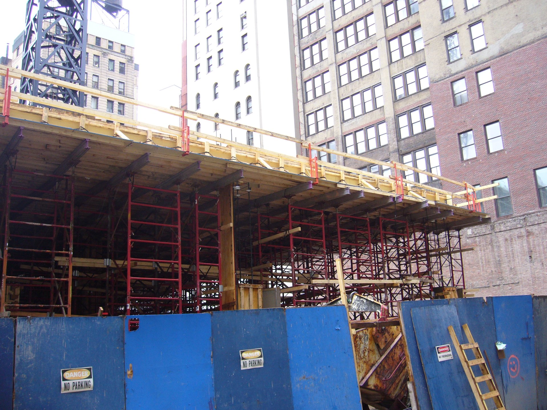 Formed podium deck carried on shoring at street level