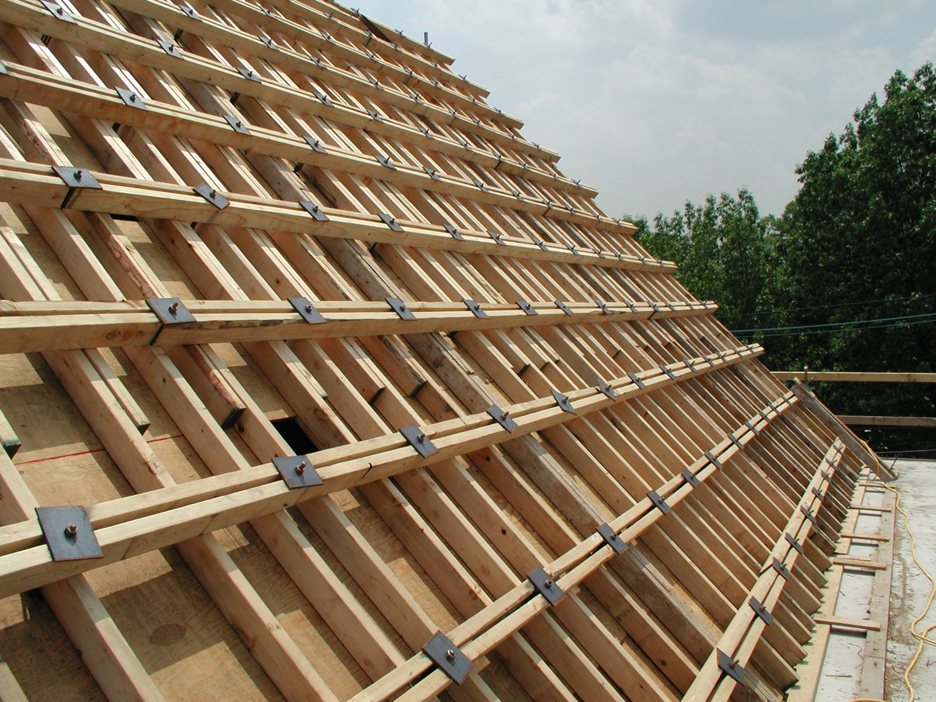 The raked roof form surface, built up plank by plank