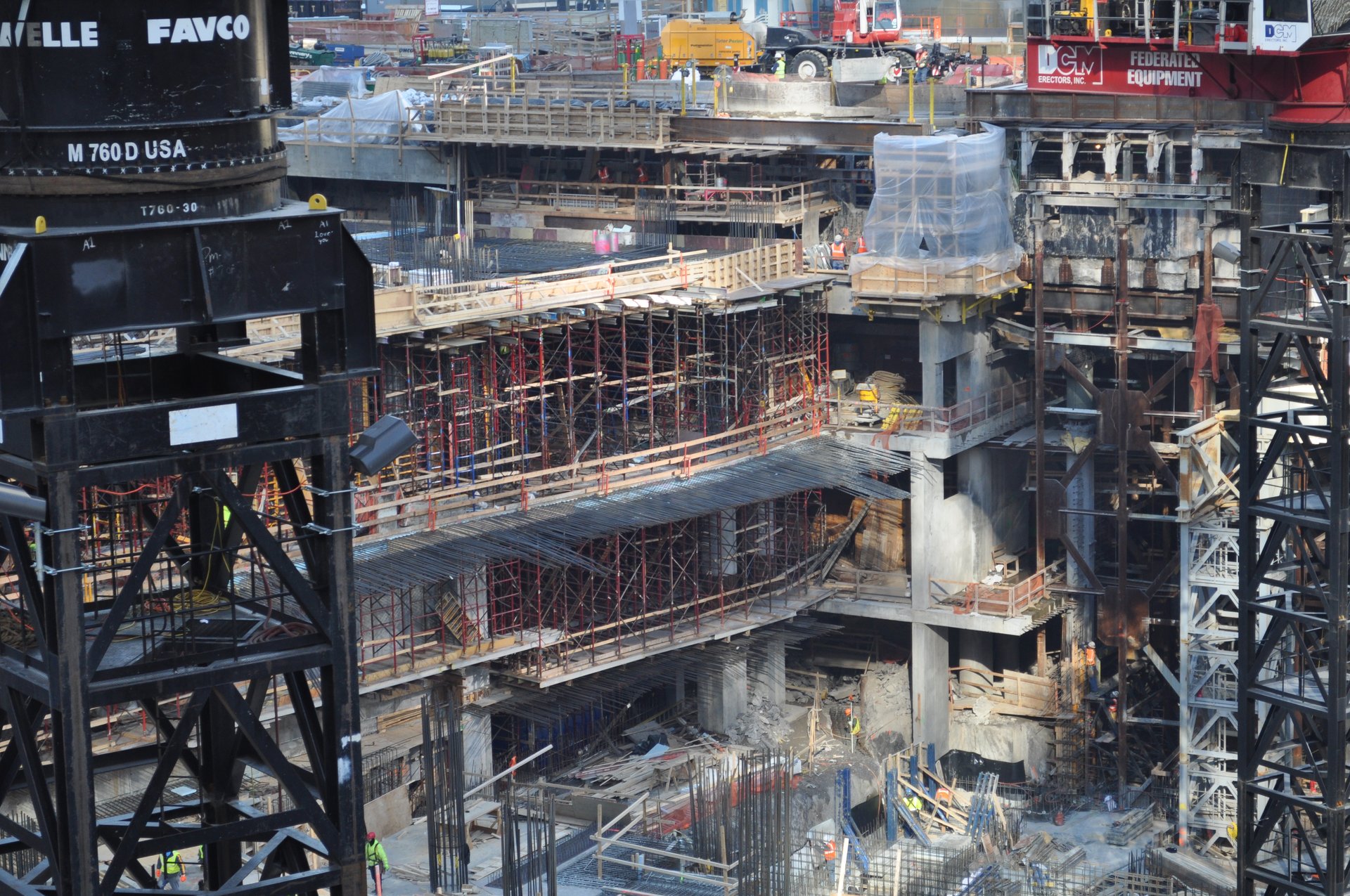 Below-grade work across the site, tower cranes overhead