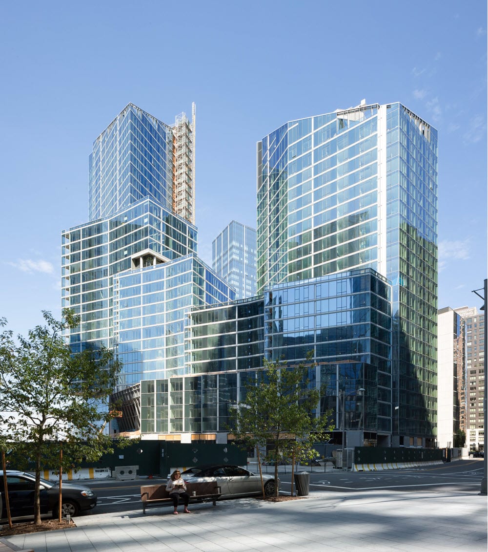 The finished trio of glass towers above the landscaped streetfront