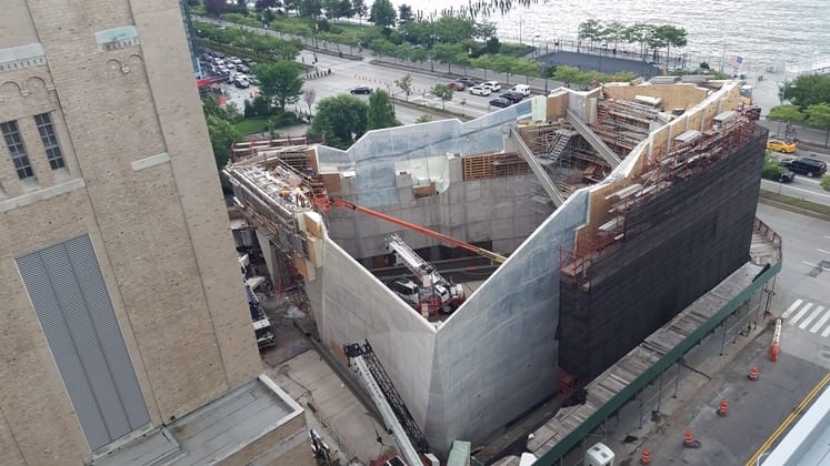 The faceted concrete walls taking shape, forms still on the upper lifts